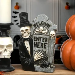 12 in. Halloween Skeleton Holding a Tombstone Decoration